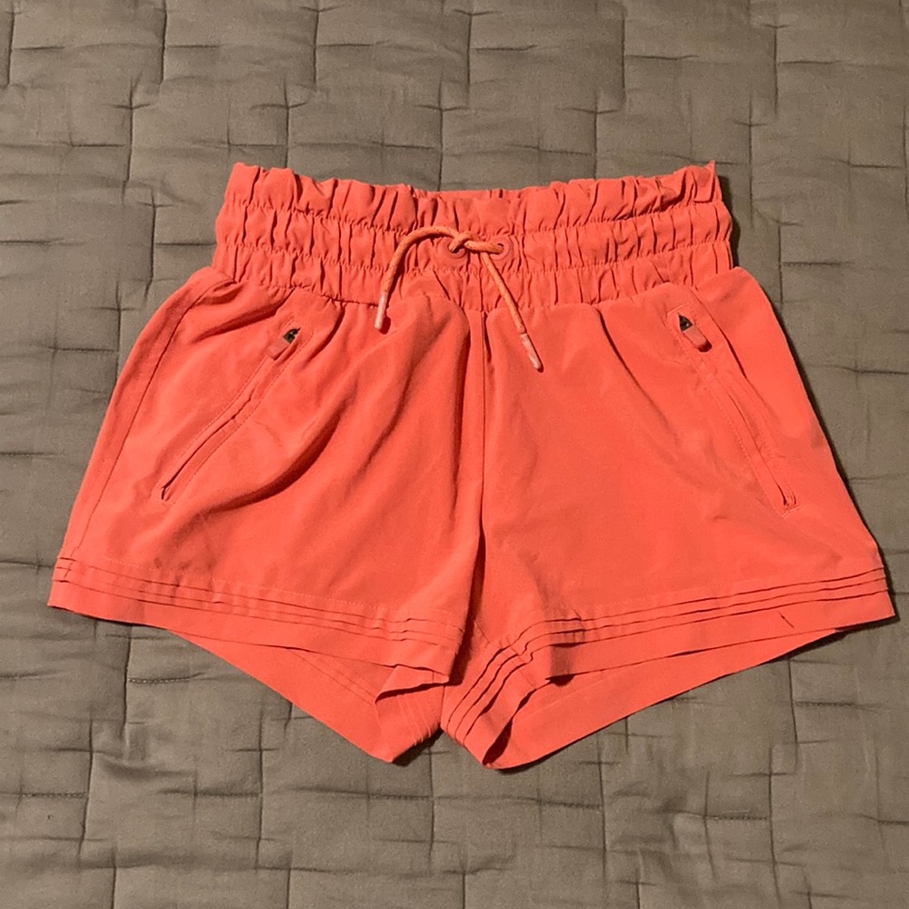Coral Athleta Girl Shorts with Elastic Waistband and Lightweight Fabric